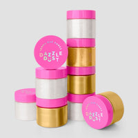 Three packages of Jenna Rae Cakes Antique Gold Edible Lustre Dust (20g each, 3 jars per pack) are stacked in uneven columns. The metallic gold jars have bright pink lids with white and blue text, against a plain light gray background.