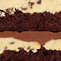 A close-up of Jenna Rae Cakes’ Brownies for 2: two stacked brownie bars layered with chocolate chip cookie dough and finished with a smooth chocolate topping.