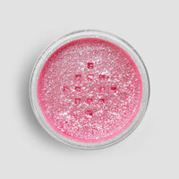 A round container of Jenna Rae Cakes Lollipop Edible Glitter (5g Shaker, Pack of 6) filled with shimmery pink glitter is seen from above against a plain light gray background.