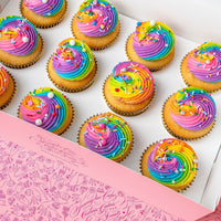 Jenna Rae Cakes’ Rainbow Cupcakes come in a light pink, whimsically patterned box. Each dozen features cupcakes with rainbow swirl frosting and assorted sprinkles.