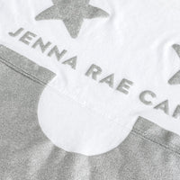 The Jenna Rae Cakes White and Silver Spirit Jersey features silver glittery stars, JENNA RAE CA text, and a large silver glitter semicircle on white fabric.