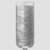 A sparkling silver liquid in a clear champagne flute showcases Jenna Rae Cakes’ Disco Ball Edible Glitter (20g, 3-pack), set against a light gray background.