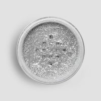 A round 5g shaker of Jenna Rae Cakes Disco Ball Edible Glitter, filled with loose, sparkling silver powder, viewed from above against a light gray background. Sold as a package of 6.