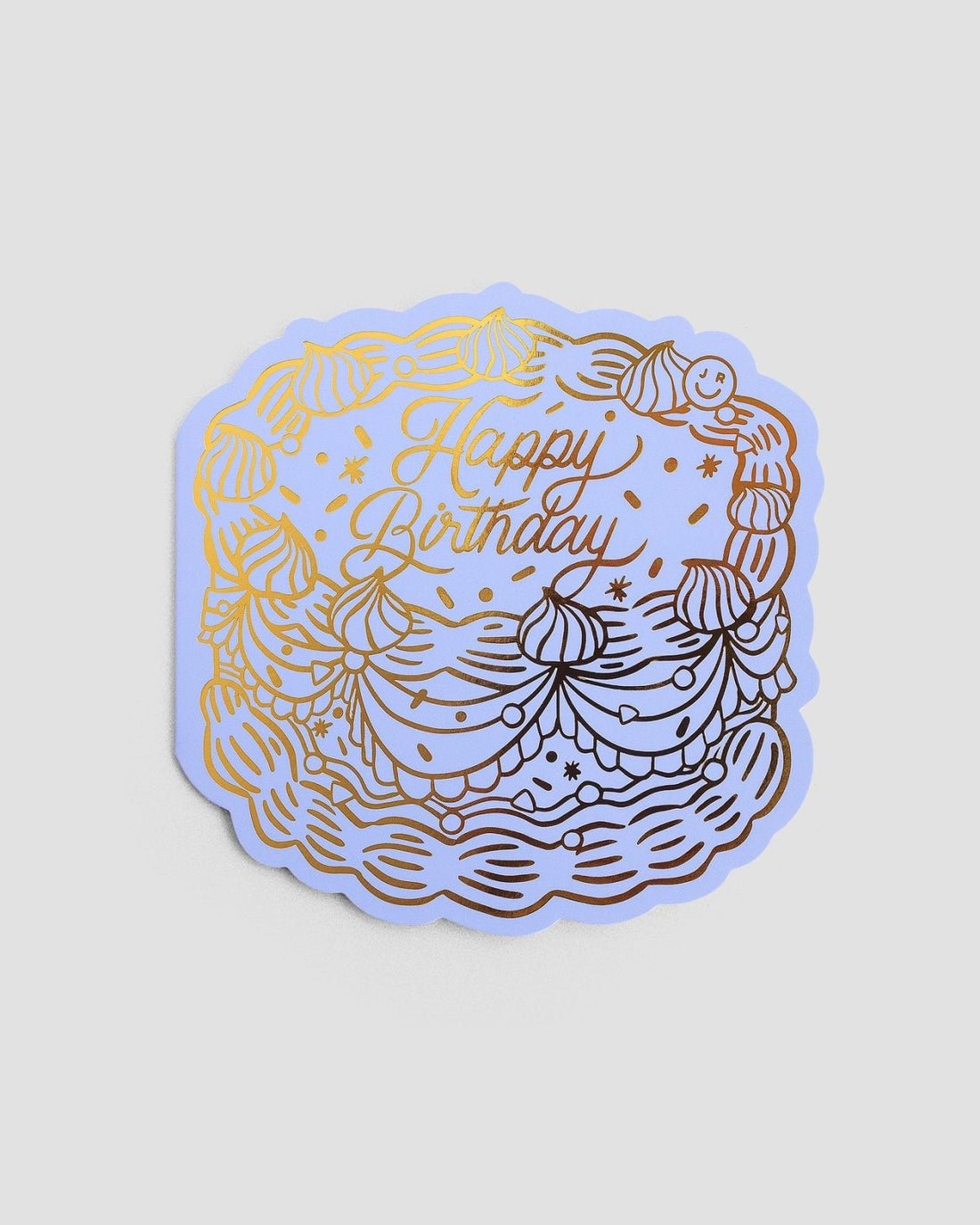 The Jenna Rae Cakes Happy Birthday Greeting Card features a cake illustration with swirls, stars, and a smiley face, topped with “Happy Birthday” in cursive gold foil.