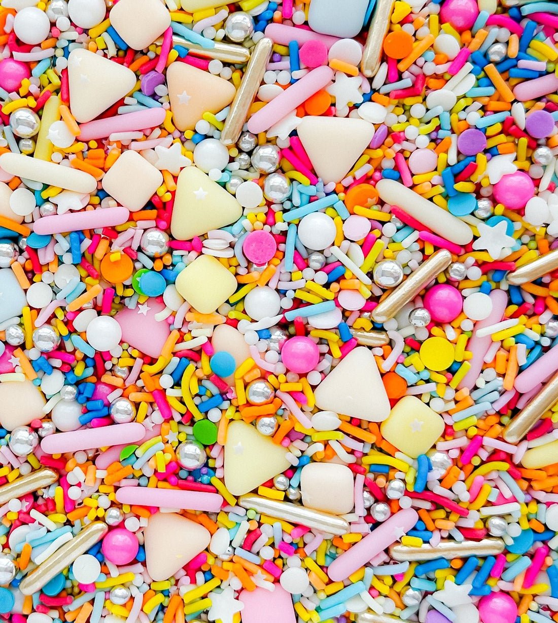 JRC Candy Sprinkles by Jenna Rae Cakes feature a vibrant mix of rods, balls, stars, triangles, and discs in pastel and bright pink, yellow, blue, orange, white, and silver for a festive touch.