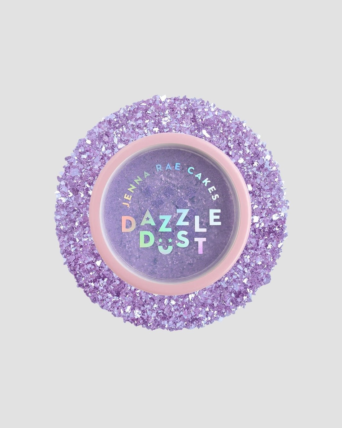 A package of six 5g shakers of Jenna Rae Cakes Lavender Haze Edible Glitter, each with a pink lid and iridescent label, sits among sparkling purple sugar crystals.