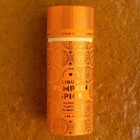 A small orange bottle of Jenna Rae Cakes Liquid Pumpkin Spice (Package of 6) with decorative patterns stands upright on a textured orange surface.