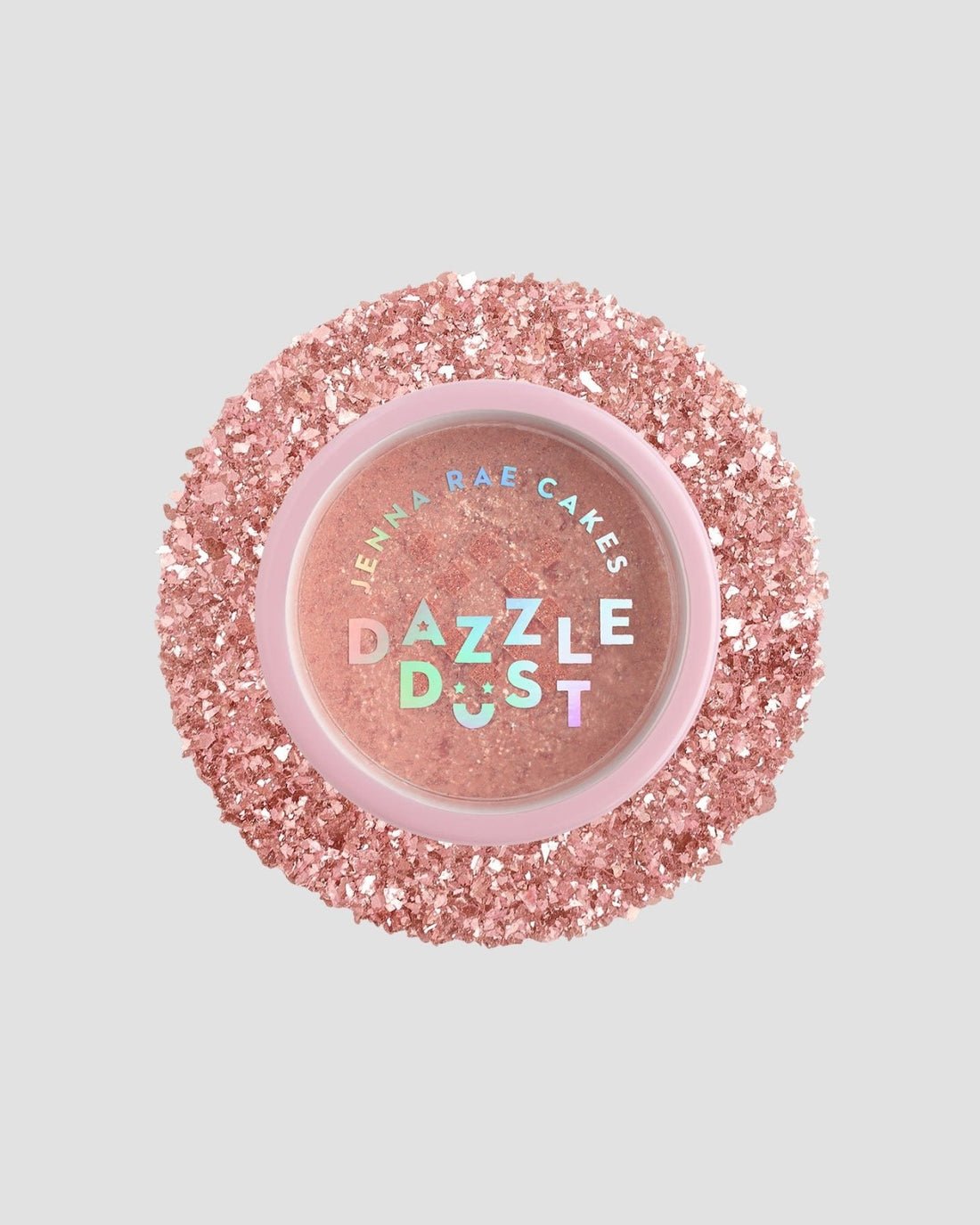A round shaker of Jenna Rae Cakes Lucky Penny Edible Glitter (5g), with a pink lid featuring iridescent lettering, surrounded by sparkling pink glitter flakes. The pack includes 6 shakers. The background is light gray.