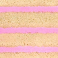 Close-up of the Reveal Works Cake by Shop Jenna Rae Cakes, featuring three layers of light yellow sponge with bright pink frosting between each layer, highlighting the cakes texture and vibrant colors.