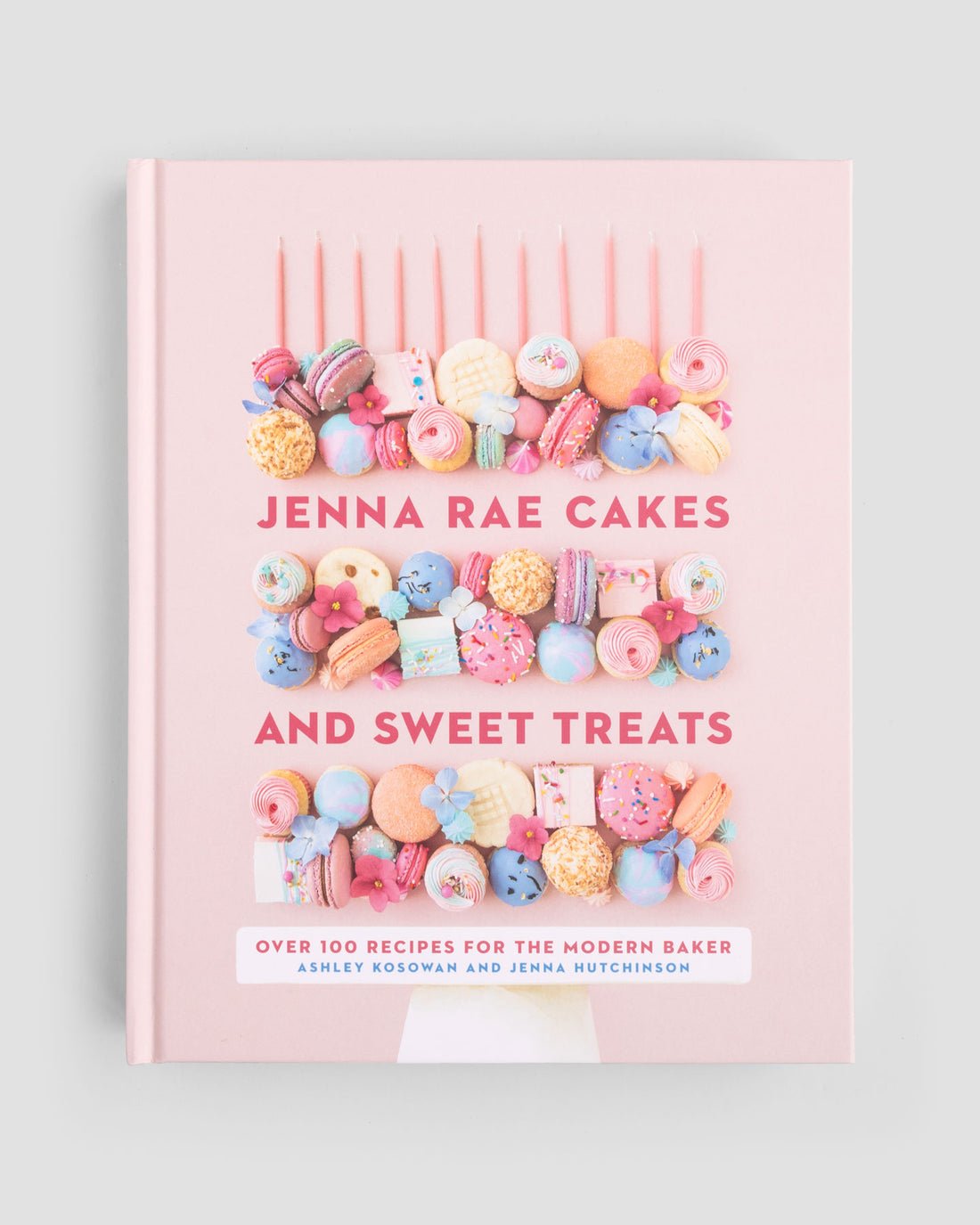 The Jenna Rae Cakes and Sweet Treats Cookbook by Jenna Rae Cakes showcases colorful macarons, cookies, and candies on its pink cover, with over 100 recipes for the modern baker by Ashley Kosowan and Jenna Hutchinson.