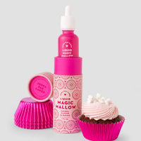 A bright pink Jenna Rae Cakes Liquid Magic Mallow bottle stands next to stacked pink cupcake liners and a chocolate cupcake with pink frosting and mini marshmallows on a light gray background.
