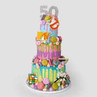 The One-of-a-Kind Cake by Jenna Rae Cakes is a vibrant three-tier treat adorned with pastel icing, macarons, and 1980s-themed toppers—Rubiks Cube, cassette tape, MTV logo, Ghostbusters sign, and the number 50.