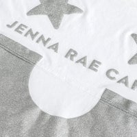The Jenna Rae Cakes White and Silver Spirit Jersey features silver glittery stars, JENNA RAE CA text, and a large silver glitter semicircle on white fabric.