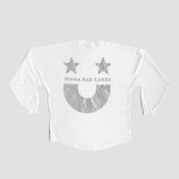 The White and Silver Spirit Jersey by Jenna Rae Cakes features two gray stars, “JENNA RAE CAKES” text, and a large gray smiley face on the back, shown on a plain gray background.