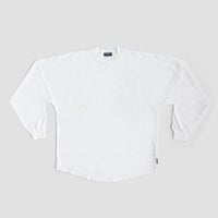A Jenna Rae Cakes White and Silver Spirit Jersey is laid flat on a light gray background, featuring long sleeves, ribbed cuffs, and a small dark tag on the lower side seam. No visible patterns or logos are present.