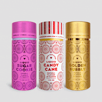 Three vibrant Build Your Own Liquid Flavour Trio bottles by Jenna Rae Cakes—Sugar Cookie (pink), Candy Cane (red/white), and Golden Bubbly (gold)—stand side by side, each with bold text and decorative patterns on the front.