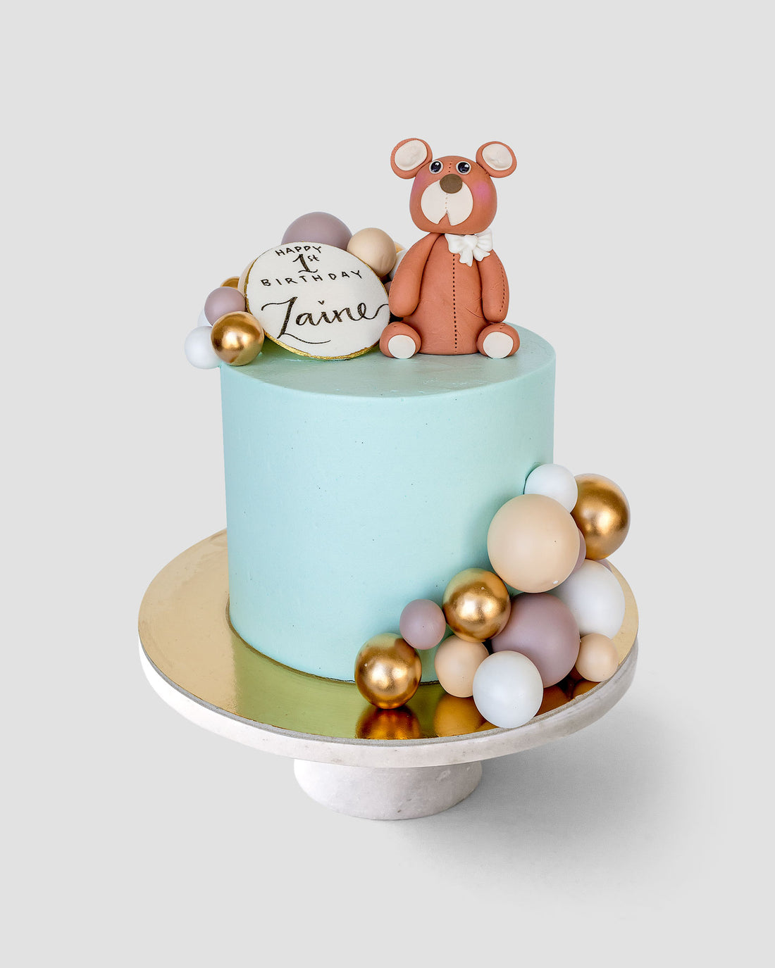 Design This Cake - Cake Size: 6" | Animal Topper: Brown Baby Bear | Cake Colour: Sky Blue | Decorative Balloon Colour Palette: Dark Brown, Light Brown, Cream Gold