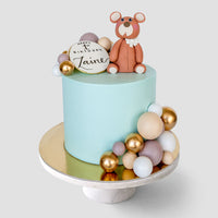 Design This Cake - Cake Size: 6" | Animal Topper: Brown Baby Bear | Cake Colour: Sky Blue | Decorative Balloon Colour Palette: Dark Brown, Light Brown, Cream Gold