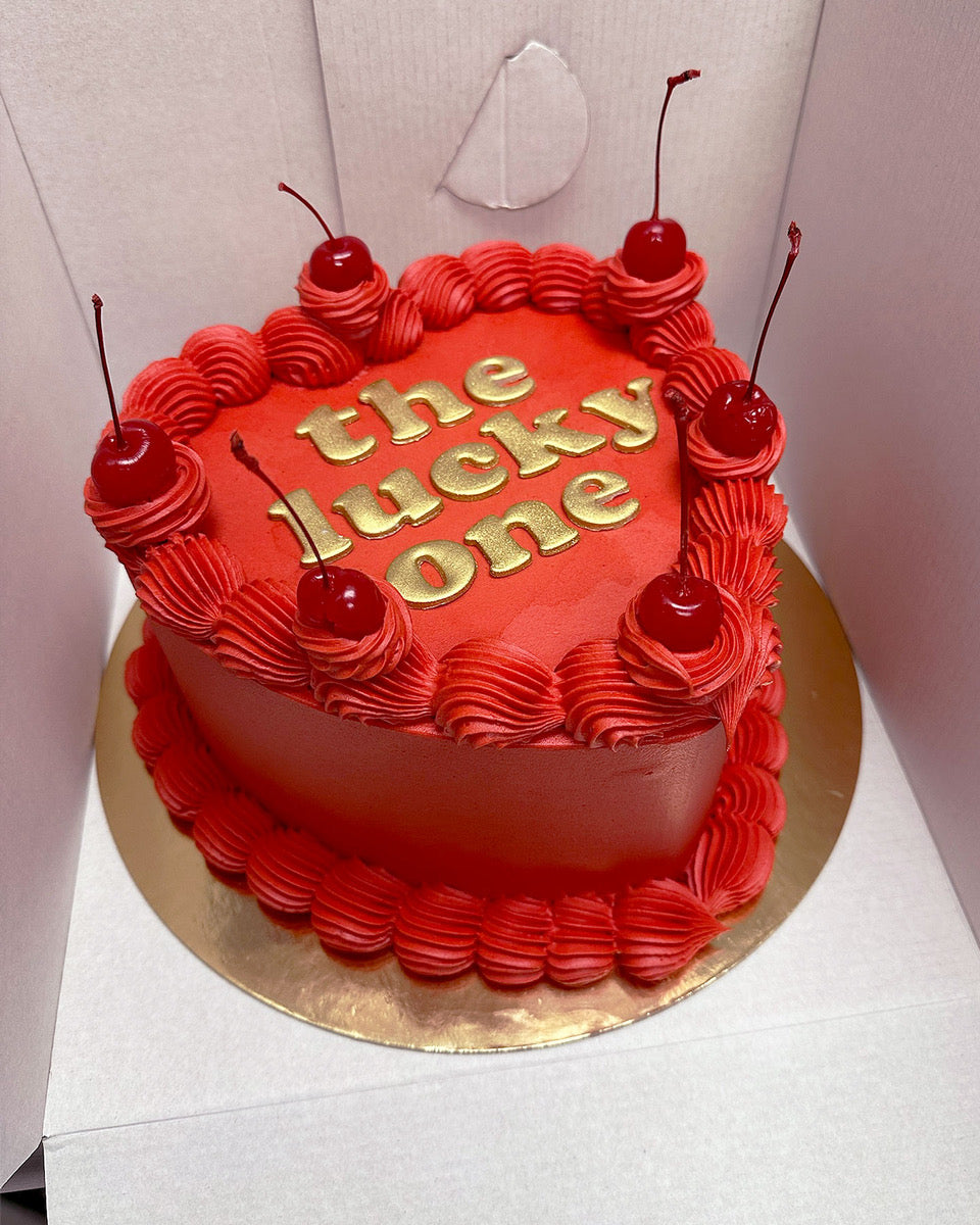 Design This Cake - Cake Size: Tall | Cake Colour: Red | Piping Style: Simple | Piping Colour: Red | Add Cherries | Add Gold Lettering