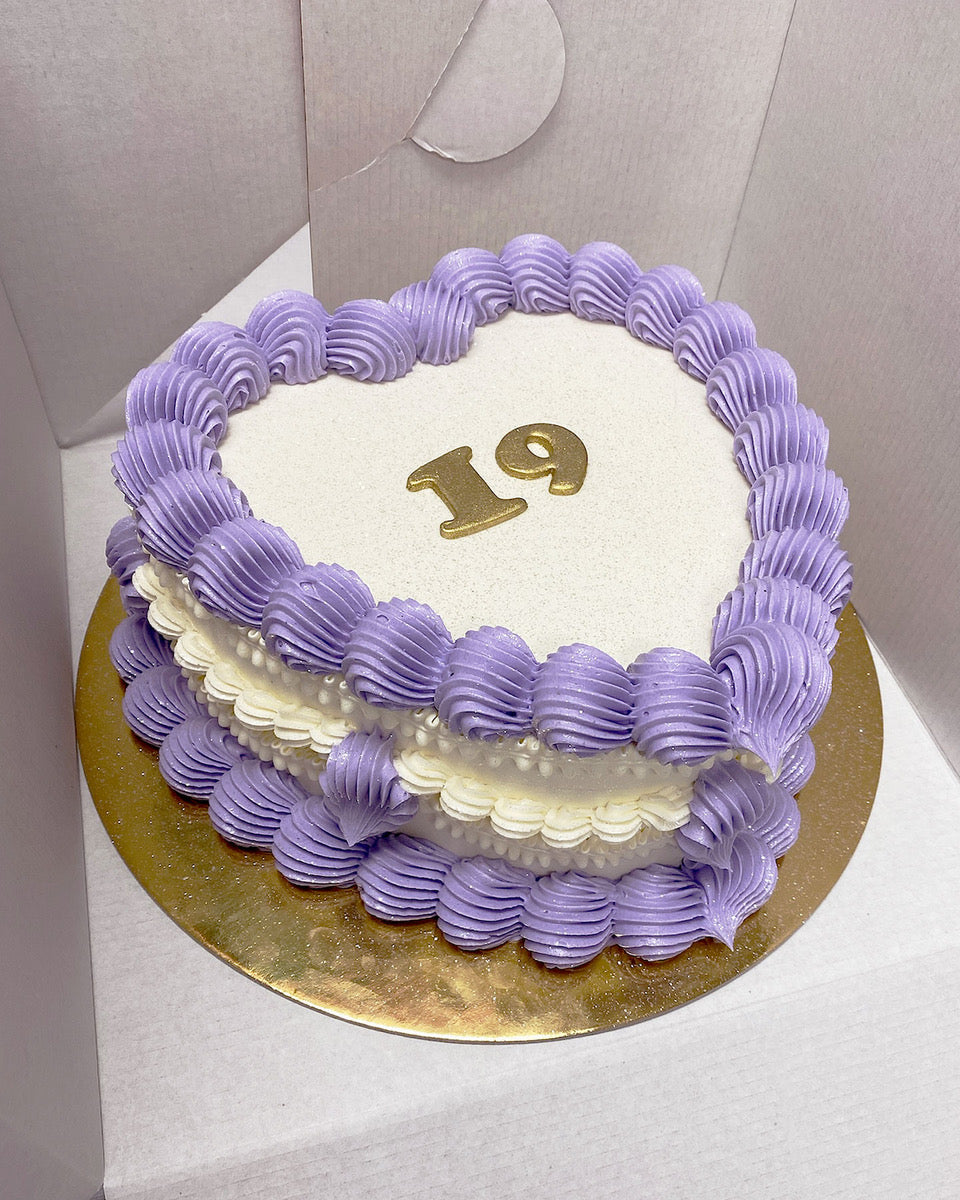 Design This Cake:  Cake Size: Short | Cake Colour: White | Piping Style: Fancy | 2 Piping Colours: Lavender + White | Make It Sparkle! | Add Gold Lettering