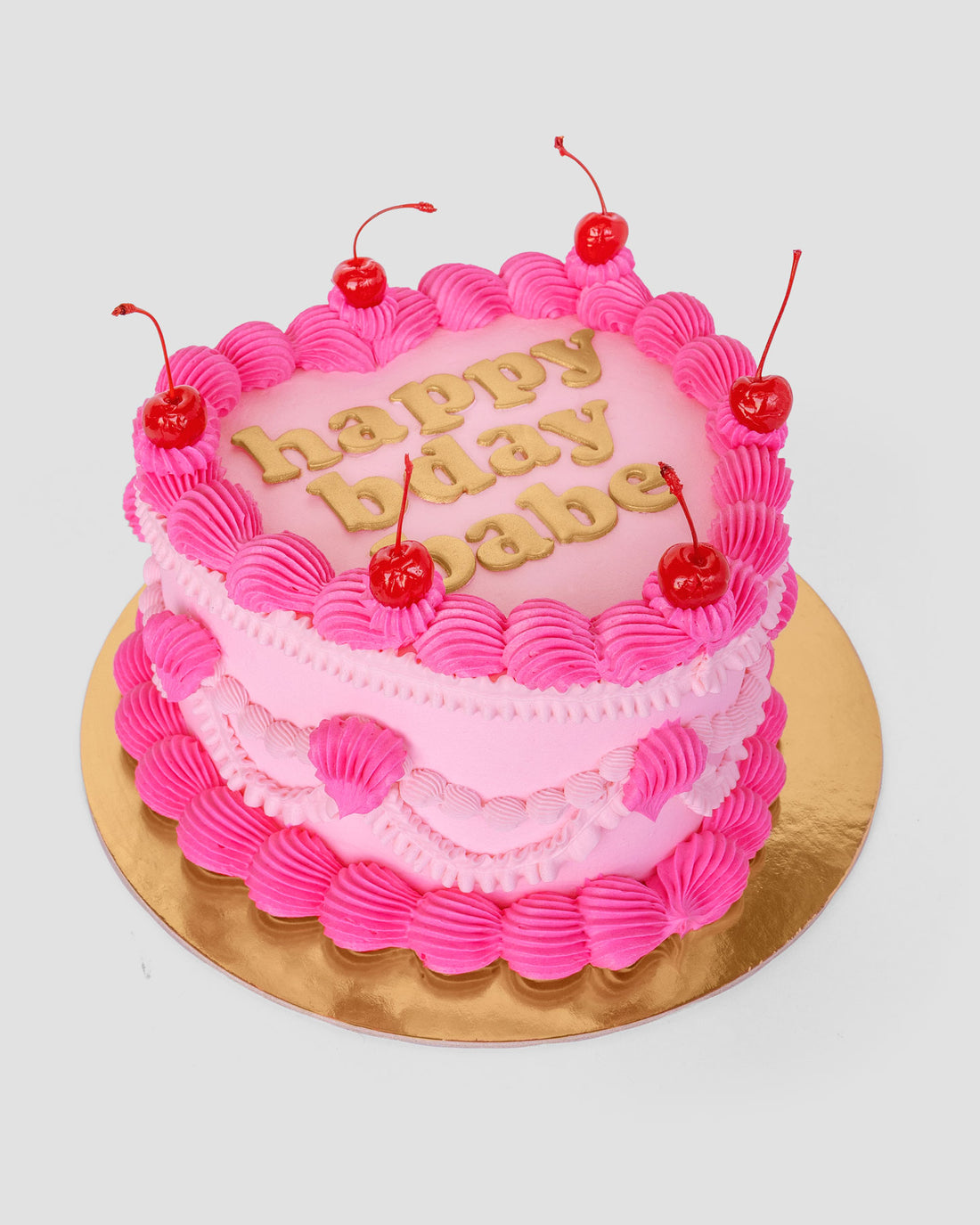 Design This Cake- Cake Size: Tall | Cake Colour: Soft Pink | Piping Style: Fancy | Piping Colours: Soft Pink + Hot Pink | Add Cherries | Add Gold Lettering
