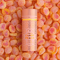 A package of 6 Jenna Rae Cakes Liquid Candy Peach containers rests on sugar-coated peach gummies. The pink and orange labels display decorative patterns and natural flavors information.