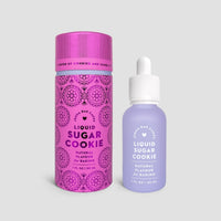Two bottles of Jenna Rae Cakes Liquid Sugar Cookie are shown: a tall pink tube with decorative patterns, and a small frosted bottle with a dropper cap and lavender label.