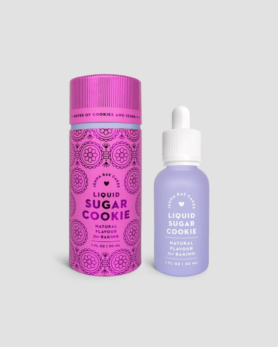 Two bottles of Jenna Rae Cakes Liquid Sugar Cookie are shown: a tall pink tube with decorative patterns, and a small frosted bottle with a dropper cap and lavender label.
