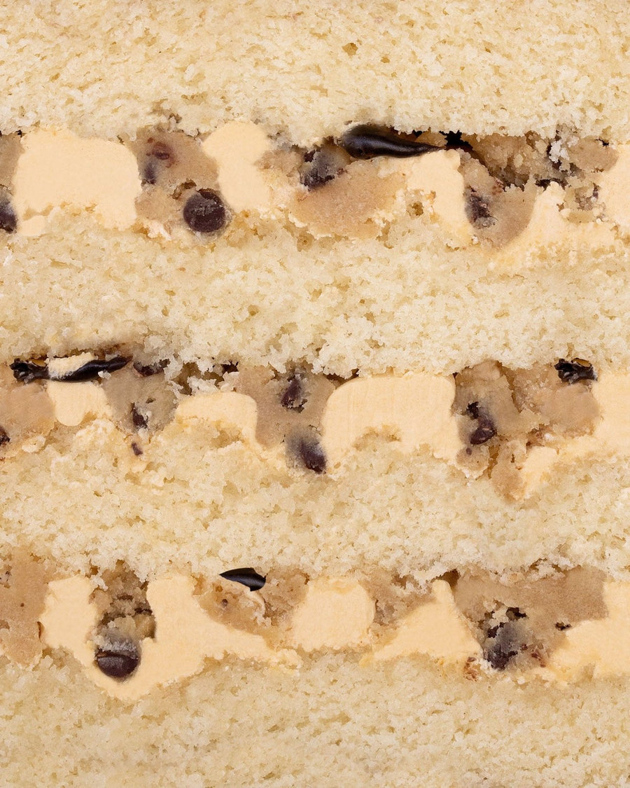 Close-up of Jenna Rae Cakes Cookie Dough Cake, featuring layers of vanilla cake, cookie dough, chocolate chips, and creamy frosting.